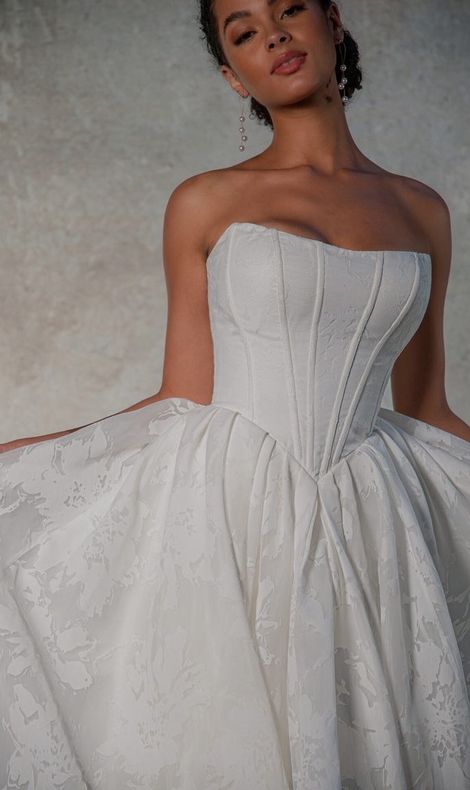 Photo of the model wearing a Essense of Australia gown