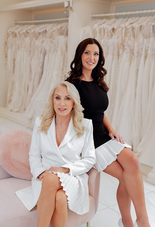Photo of the models posing near the bridal gowns